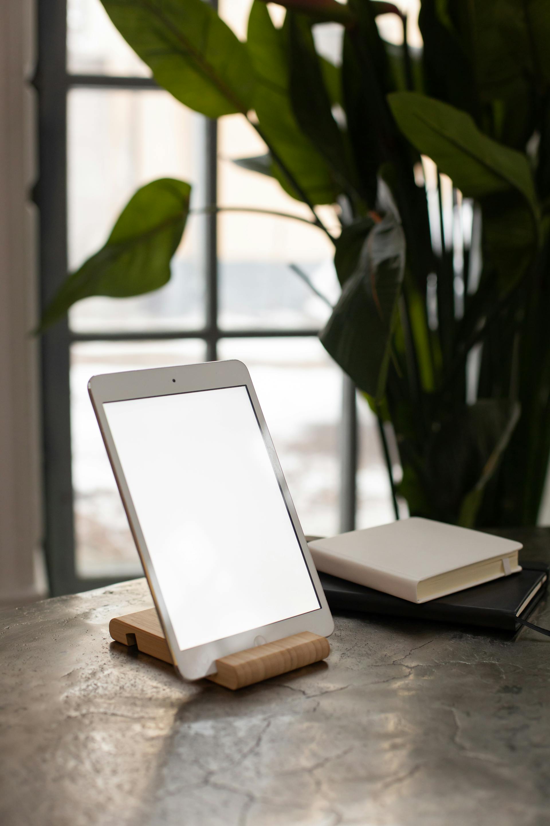 A tablet set up for learning on a bedside surface